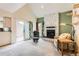 Bright living room featuring a stone fireplace and sliding doors leading to the patio at 461 S Kalispell Way # D, Aurora, CO 80017
