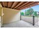 Private outdoor patio with a view of the community green space and mature trees at 461 S Kalispell Way # D, Aurora, CO 80017