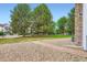 Well-maintained lawn and landscaping with mature trees, shrubs and pebble walkway at 461 S Kalispell Way # D, Aurora, CO 80017