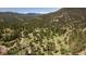 Breathtaking aerial shot of a residential area surrounded by mountain views and lush forest at 107 Elk Dr, Evergreen, CO 80439