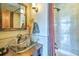 Stylish bathroom featuring a glass vessel sink, tiled shower, and modern fixtures for a spa-like experience at 107 Elk Dr, Evergreen, CO 80439