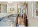 Bathroom with dual vessel sinks, modern fixtures, and a view of an adjoining bedroom and window at 107 Elk Dr, Evergreen, CO 80439