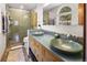Bathroom with a dual sink vanity and a large glass shower with tiled floors at 107 Elk Dr, Evergreen, CO 80439