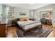 Cozy bedroom featuring wood floors, a bay window, and decor art at 107 Elk Dr, Evergreen, CO 80439