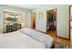 Bedroom with wood floors, walk-in closet, and a desk with mountain view at 107 Elk Dr, Evergreen, CO 80439