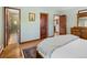 Bright bedroom features wood floors, wood trim, and multiple doors at 107 Elk Dr, Evergreen, CO 80439