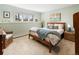 Bright bedroom featuring a bed, wicker chair, and a mountain view window at 107 Elk Dr, Evergreen, CO 80439