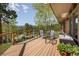 Enjoy the mountain views from this spacious wooden deck with stylish outdoor furniture at 107 Elk Dr, Evergreen, CO 80439