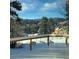 Winter view from the deck highlighting the snow covered grounds and trees in the background at 107 Elk Dr, Evergreen, CO 80439
