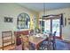 Elegant dining room featuring a wooden table with seating for six and sliding glass doors at 107 Elk Dr, Evergreen, CO 80439