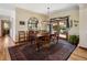 Dining room with a wooden table, decorative rug, and a large window offering natural light at 107 Elk Dr, Evergreen, CO 80439