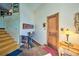 Welcoming entryway featuring a staircase, wooden door, and a console table at 107 Elk Dr, Evergreen, CO 80439