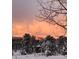 Scenic winter landscape with snow-covered trees and a colorful sky creating a picturesque natural view at 107 Elk Dr, Evergreen, CO 80439