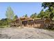Charming home featuring a two-car garage, a stone facade, and a large wooden deck at 107 Elk Dr, Evergreen, CO 80439