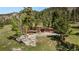 Mid-century modern home with mature trees sits on a large lot overlooking a valley and surrounding mountains at 107 Elk Dr, Evergreen, CO 80439