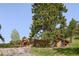 Attractive house with a long driveway and a separate storage shed, set against a backdrop of tall trees at 107 Elk Dr, Evergreen, CO 80439
