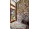 Inviting foyer featuring a stone accent wall, wood door, and tiled floor at 107 Elk Dr, Evergreen, CO 80439