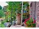 Charming front porch with lots of plants, greenery, and brick exterior at 107 Elk Dr, Evergreen, CO 80439