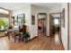Hallway with wood floors featuring a piano and doorway views into adjoining rooms at 107 Elk Dr, Evergreen, CO 80439