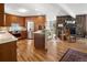 Open concept kitchen with wooden cabinetry, stainless steel appliances, and hardwood floors at 107 Elk Dr, Evergreen, CO 80439