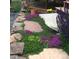 An elevated and creative landscape view, full of healthy plants and stone at 107 Elk Dr, Evergreen, CO 80439