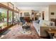 Inviting living room featuring wood floors, high ceilings, a piano, and access to a wooden deck at 107 Elk Dr, Evergreen, CO 80439