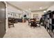 Spacious living room with seating area, dining table, and expansive bookshelf, providing ample space for activities at 107 Elk Dr, Evergreen, CO 80439