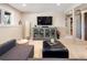 Spacious living room with gray sofa, entertainment center, and sliding barn door at 107 Elk Dr, Evergreen, CO 80439
