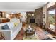 Open concept living room with stone fireplace, hardwood floors, and comfortable seating at 107 Elk Dr, Evergreen, CO 80439
