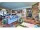 Inviting living room featuring a stone fireplace, comfortable seating, and open layout for relaxation and entertainment at 107 Elk Dr, Evergreen, CO 80439