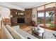 Living room with stone fireplace, hardwood floors, and sliding doors to the outdoor deck at 107 Elk Dr, Evergreen, CO 80439
