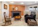 Living room featuring a tiled fireplace with an orange accent wall at 107 Elk Dr, Evergreen, CO 80439