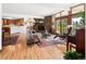 Open concept living room featuring wood floors, stone fireplace, and access to the outdoors at 107 Elk Dr, Evergreen, CO 80439