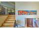 Open staircase featuring wood steps, a wrought-iron railing, and artwork on the walls at 107 Elk Dr, Evergreen, CO 80439