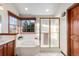 Well-lit bathroom featuring a jetted tub under a window and a tiled shower with glass door at 8187 N Pinewood Dr, Castle Rock, CO 80108