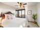 Bedroom with ceiling fan, double hung window, and comfortable bed with stylish pillows at 8187 N Pinewood Dr, Castle Rock, CO 80108