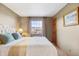 Bedroom with a plush bed, side table, curtains, and a framed print on the wall at 8187 N Pinewood Dr, Castle Rock, CO 80108