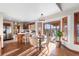 Sunlit breakfast nook featuring hardwood floors, a breakfast bar, and backyard access at 8187 N Pinewood Dr, Castle Rock, CO 80108