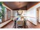 Formal dining room featuring decorative wainscoting, hardwood floors, and contemporary lighting at 8187 N Pinewood Dr, Castle Rock, CO 80108