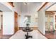 Spacious foyer with light tile floors, white walls, wood trim, and decorative furniture at 8187 N Pinewood Dr, Castle Rock, CO 80108