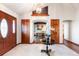 Elegant foyer featuring tile floors, white walls, and decorative doorway to dining room at 8187 N Pinewood Dr, Castle Rock, CO 80108