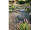 Landscaped front yard featuring a rock lined pond and a covered entryway to the home at 8187 N Pinewood Dr, Castle Rock, CO 80108