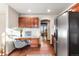 Bright kitchen featuring wood floors, stainless fridge, recessed lights, desk space and a view to the dining area at 8187 N Pinewood Dr, Castle Rock, CO 80108