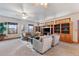 Spacious living room with large windows, neutral furniture, built-in shelving and ceiling fans at 8187 N Pinewood Dr, Castle Rock, CO 80108