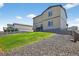 Exterior view of the home's backyard with a grassy slope and rock landscaping at 5336 Trails Edge Ln, Castle Rock, CO 80104