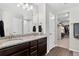 A bathroom features double sinks, a granite countertop, a shower, and access to a walk-in closet at 5336 Trails Edge Ln, Castle Rock, CO 80104