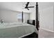 The primary bedroom includes a four-poster bed, dresser, ceiling fan, and a view outside the window at 5336 Trails Edge Ln, Castle Rock, CO 80104