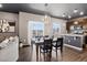 Dining area open to kitchen featuring updated lighting, island and stainless steel appliances at 5336 Trails Edge Ln, Castle Rock, CO 80104