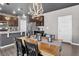 Dining room with modern lighting fixture, open to the kitchen with stainless steel appliances at 5336 Trails Edge Ln, Castle Rock, CO 80104