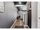Hallway with dark gray walls, black ceiling, wood floor, and bright open living spaces at 5336 Trails Edge Ln, Castle Rock, CO 80104